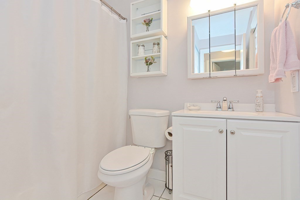 801 Franklin Crossing Road, Unit 801 Franklin, MA 02038 - Photo 22 of 38 a bathroom with a sink toilet and vanity