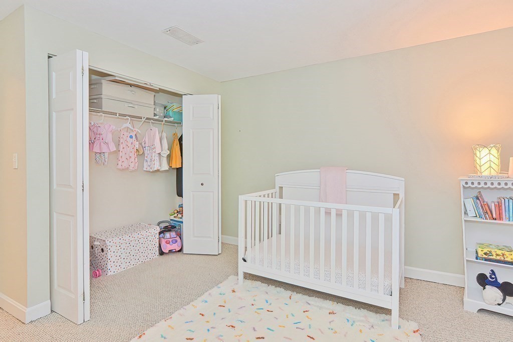 801 Franklin Crossing Road, Unit 801 Franklin, MA 02038 - Photo 25 of 38 a view of a bedroom with baby crib and toys