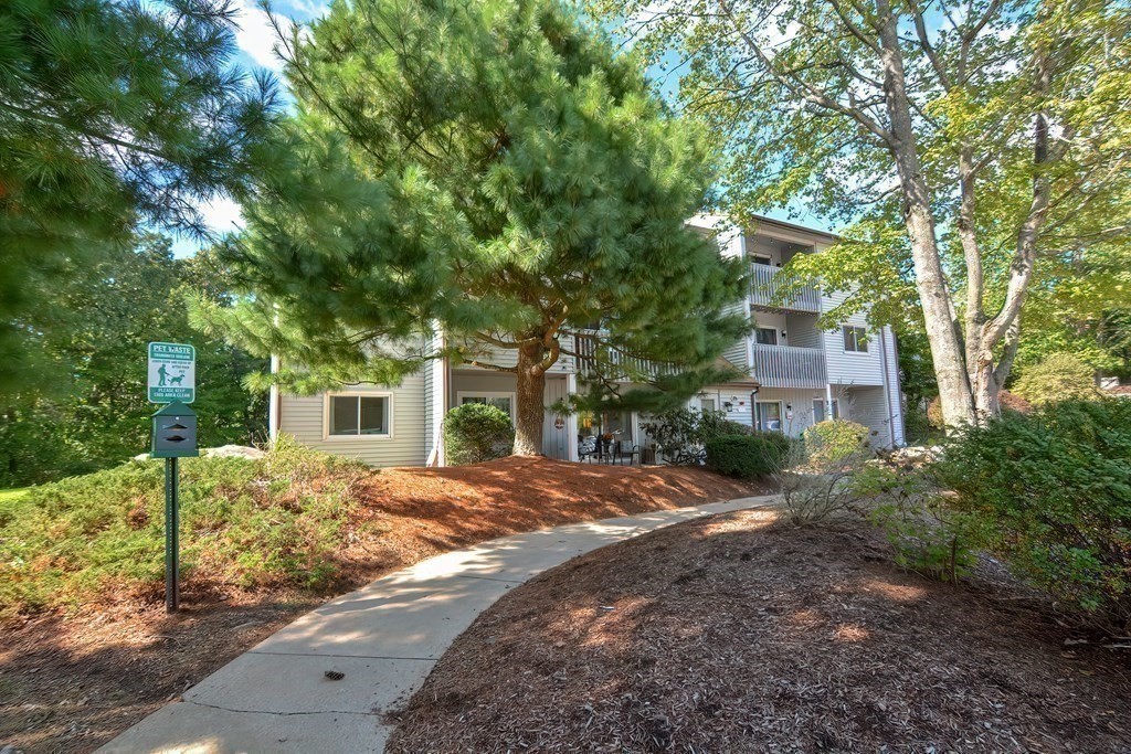 801 Franklin Crossing Road, Unit 801 Franklin, MA 02038 - Photo 27 of 38 a front view of a house with a garden