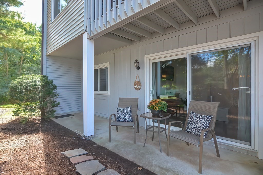 801 Franklin Crossing Road, Unit 801 Franklin, MA 02038 - Photo 28 of 38 a view of a patio with table and chairs and potted plants