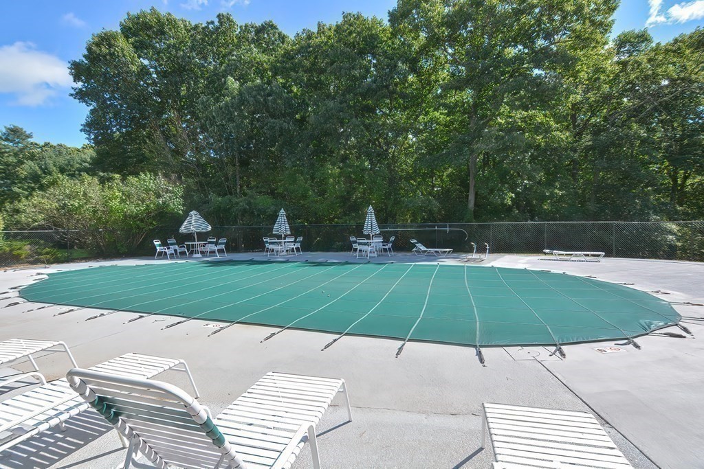 801 Franklin Crossing Road, Unit 801 Franklin, MA 02038 - Photo 32 of 38 a lawn chairs sitting under a large umbrella