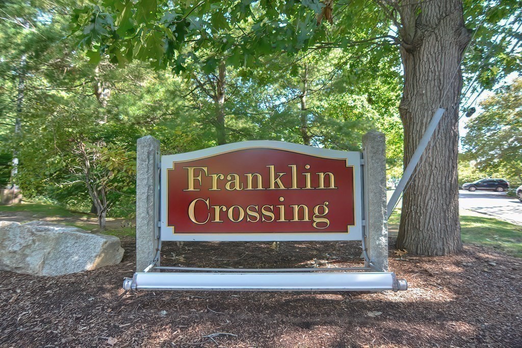 801 Franklin Crossing Road, Unit 801 Franklin, MA 02038 - Photo 38 of 38 a sign broad on the side of the road