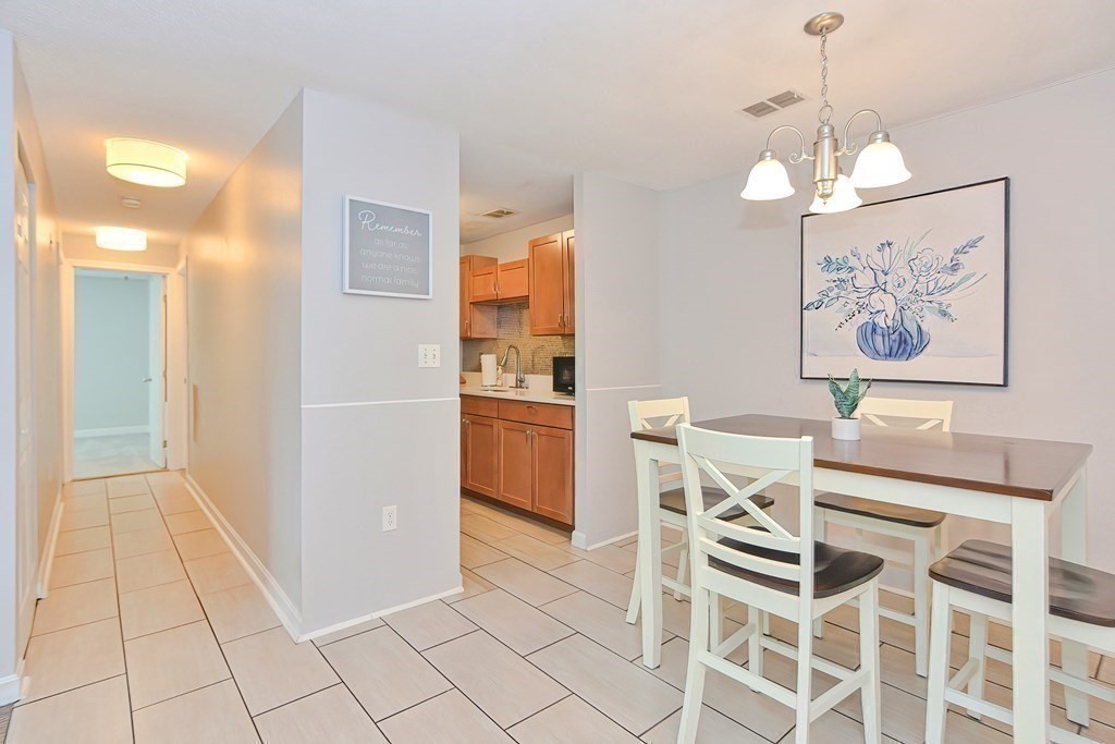 801 Franklin Crossing Road, Unit 801 Franklin, MA 02038 - Photo 5 of 38 a view of a dining room with furniture and chandelier
