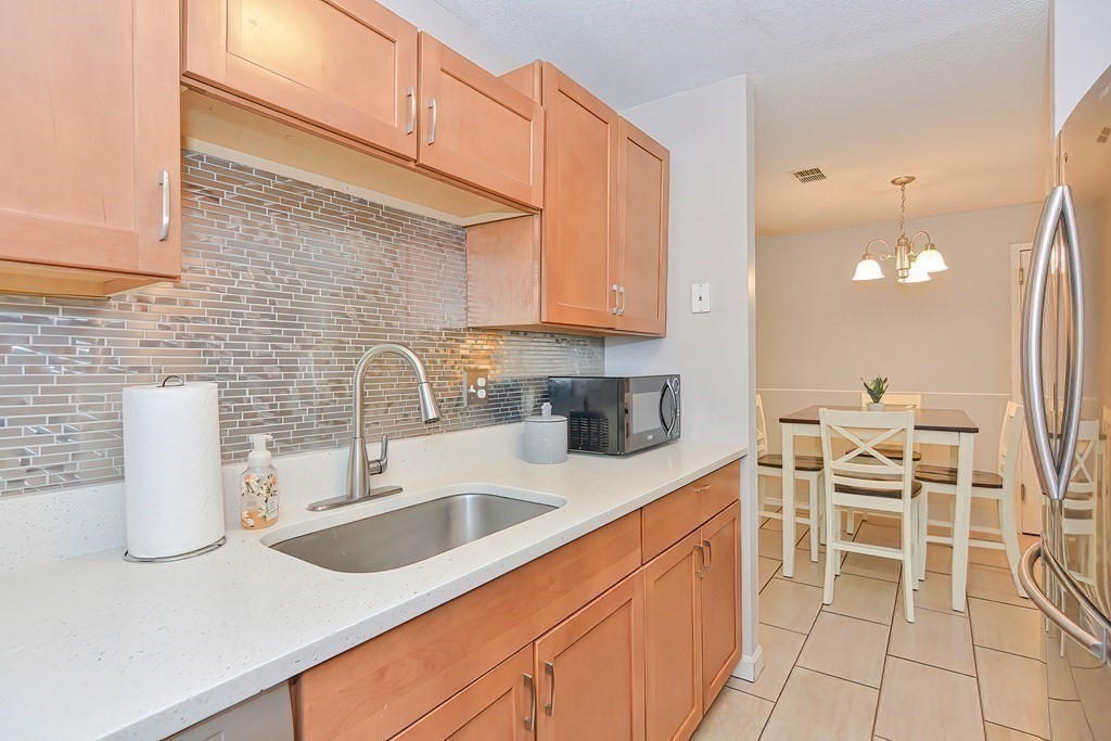 801 Franklin Crossing Road, Unit 801 Franklin, MA 02038 - Photo 8 of 38 a kitchen with a sink and cabinets