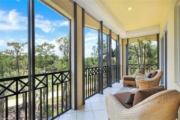 a balcony view with a couch and floor to ceiling windows