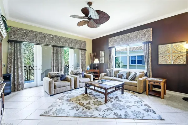 a living room with furniture a rug and a large window