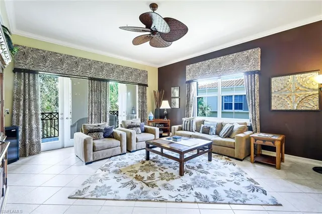 a living room with furniture a rug and a large window
