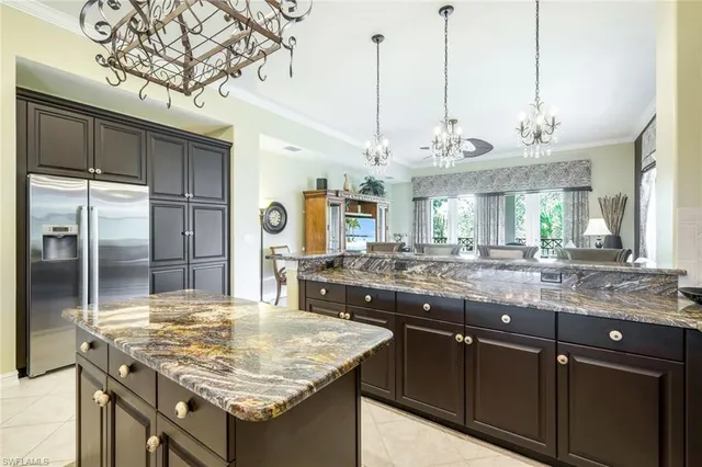 a kitchen with a counter space a sink and refrigerator