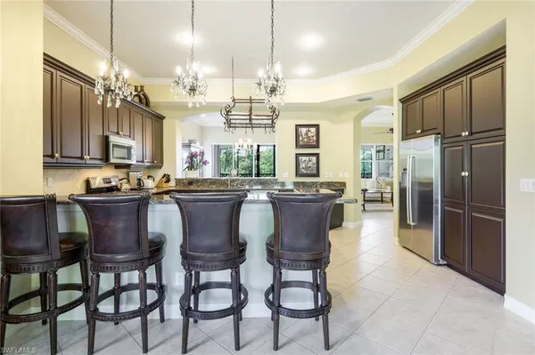 a large kitchen with a table and chairs