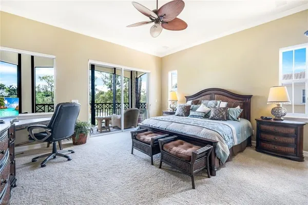 a bedroom with a bed chair and a large window