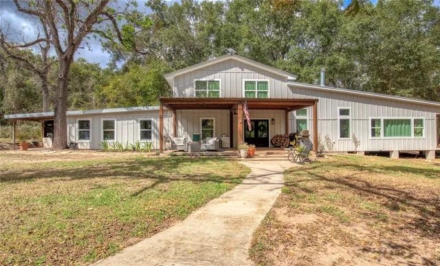 a front view of a house with a yard patio and swimming pool