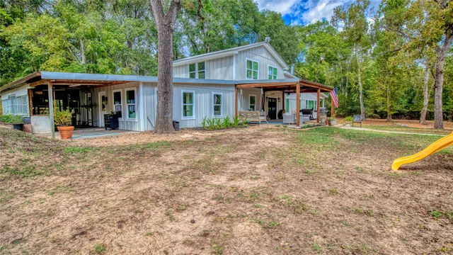 a front view of a house with a yard table and chairs