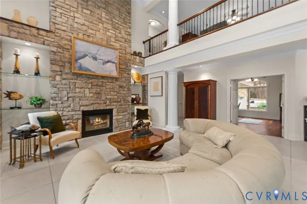 a living room with furniture a flat screen tv and a fireplace