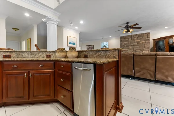 a bedroom with a bed and a mirror on dresser next to a window