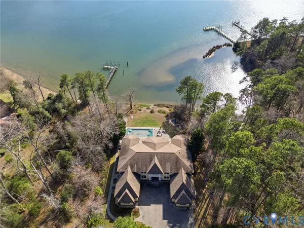 a view of a dining room with furniture a chandelier and wooden floor