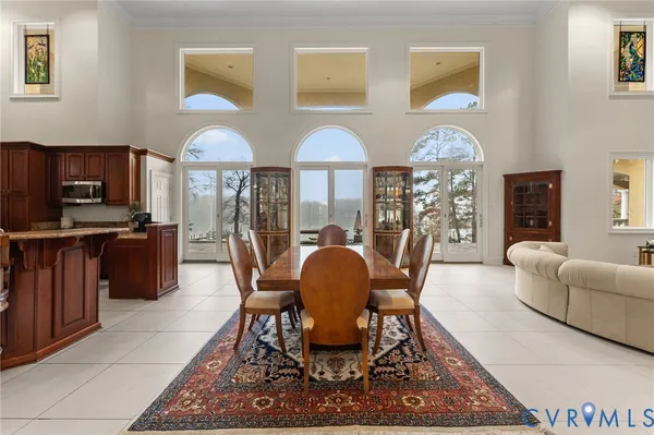 a living room with furniture a ceiling fan and a flat screen tv