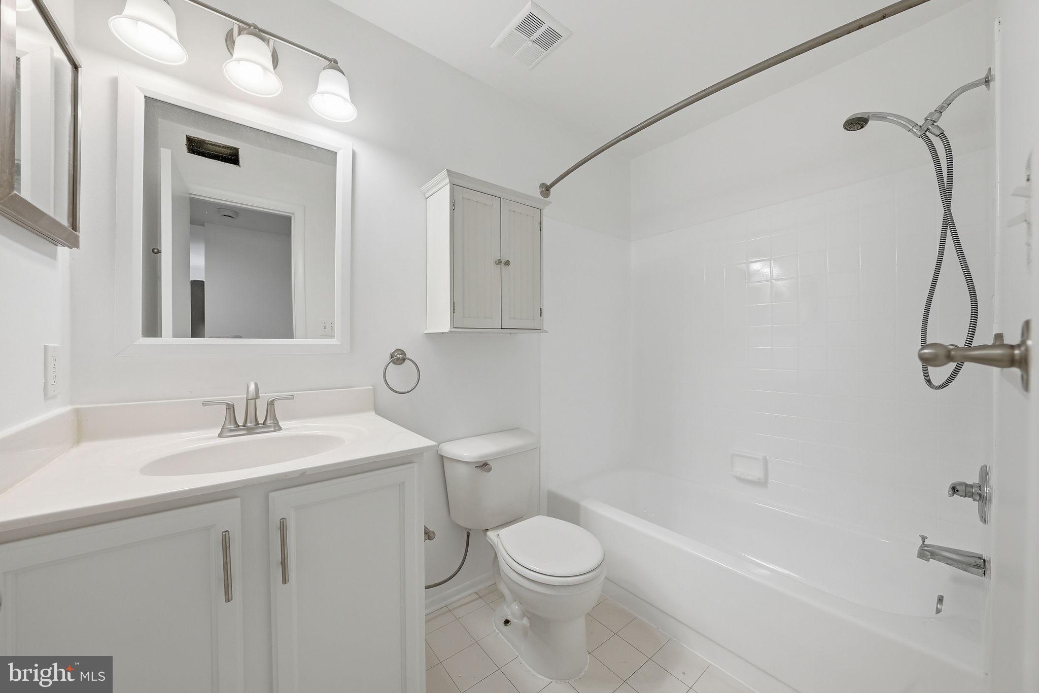 1703 Ascot Way, Unit D Reston, VA 20190 - Photo 19 of 21 a bathroom with a toilet sink vanity tub and shower