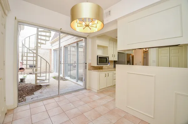 a view of a kitchen with fridge and windows