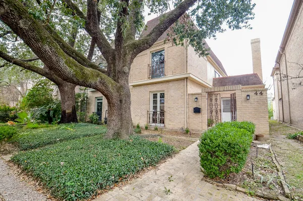 a view of a house with a tree in a yard