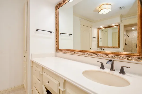 a bathroom with a sink and a mirror