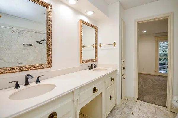 a bathroom with a granite countertop sink mirror and double