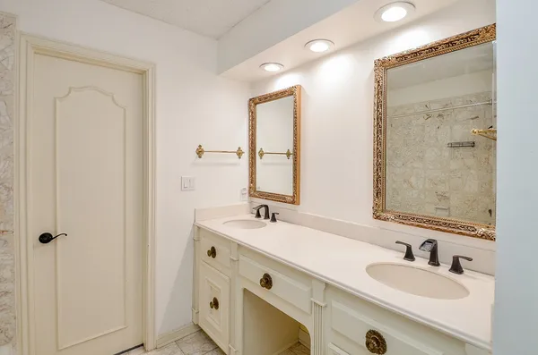 a bathroom with 2 sink tub and a mirror