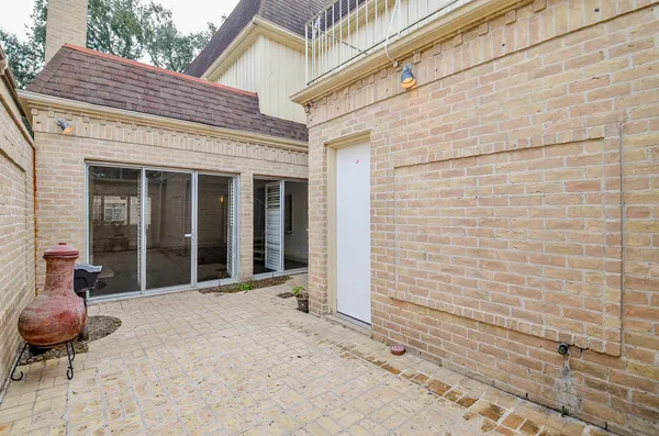 a view of a brick house with an outdoor space