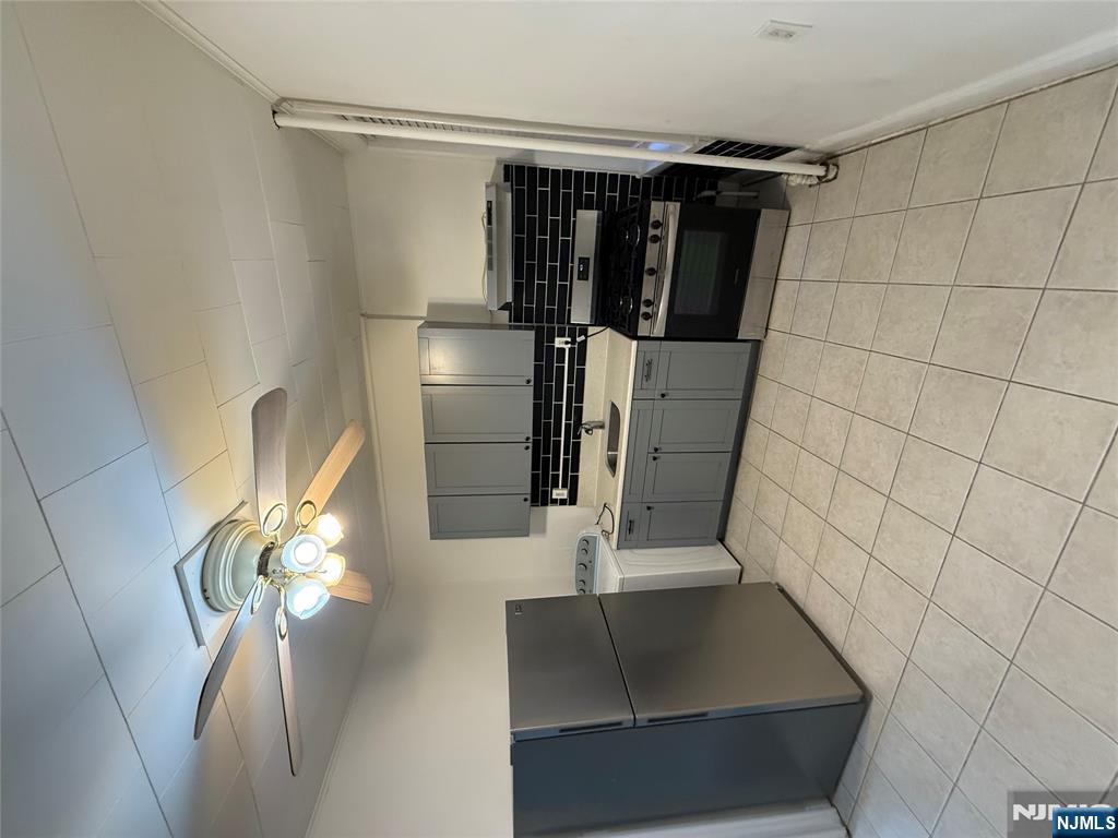 322 Anderson Avenue Fairview, NJ 07022 - Photo 7 of 13 a kitchen with cabinets and appliances