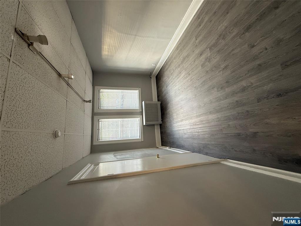322 Anderson Avenue Fairview, NJ 07022 - Photo 10 of 13 an empty room with wooden floor and windows