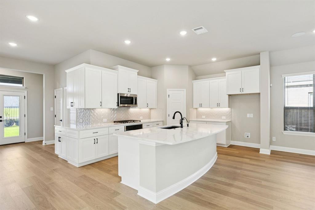 1366 Chisos Way Forney, TX 75126 - Photo 11 of 38 a large white kitchen with stainless steel appliances