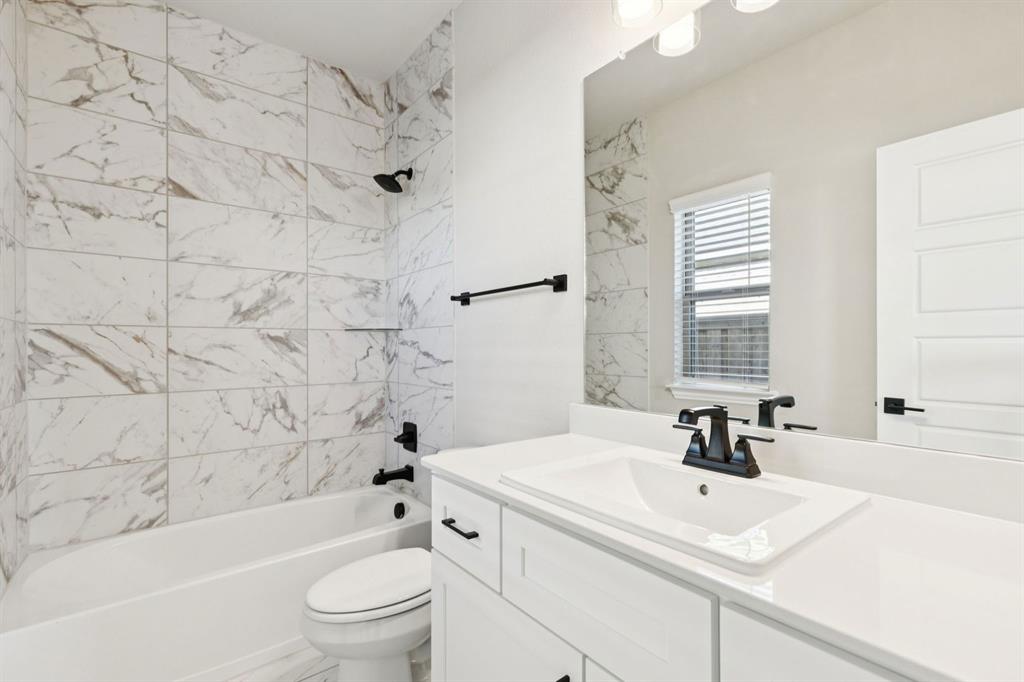 1366 Chisos Way Forney, TX 75126 - Photo 23 of 38 a bathroom with a sink a toilet and a bathtub