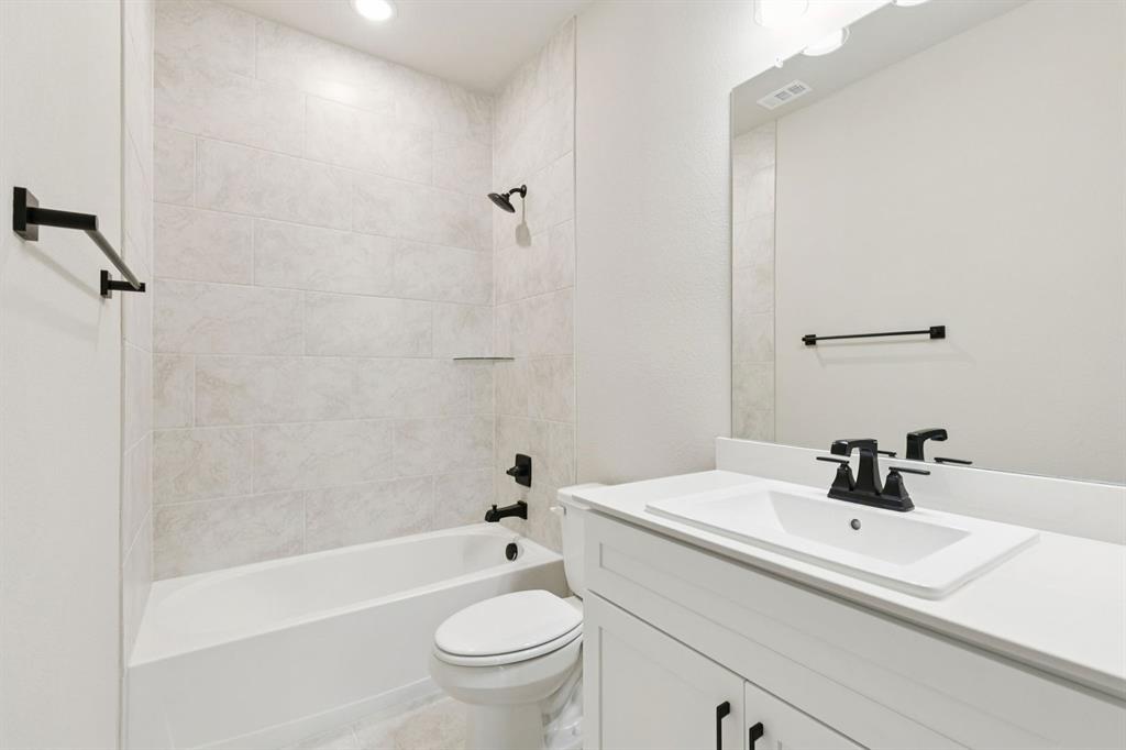 1366 Chisos Way Forney, TX 75126 - Photo 25 of 38 a bathroom with a sink a toilet and a bathtub