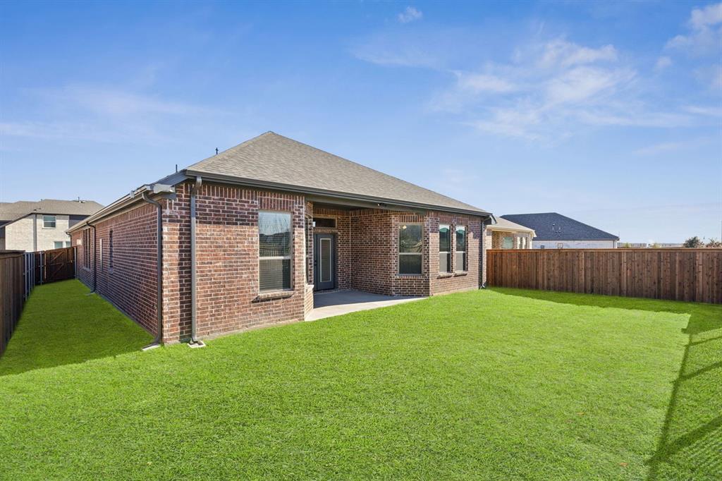 1366 Chisos Way Forney, TX 75126 - Photo 29 of 38 a view of a house with a yard and wooden fence