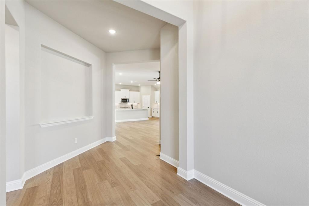 1366 Chisos Way Forney, TX 75126 - Photo 3 of 38 a view of a hallway with wooden floor