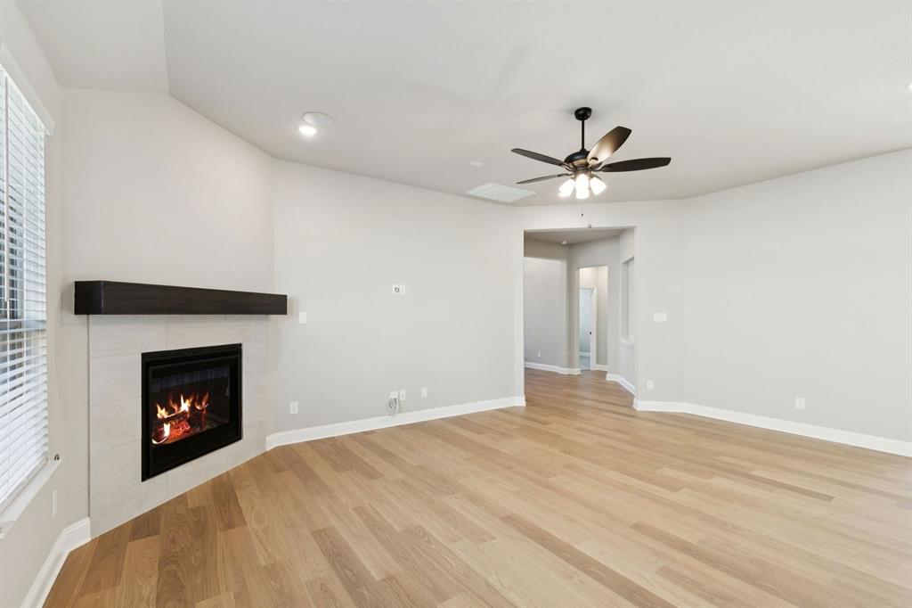1366 Chisos Way Forney, TX 75126 - Photo 6 of 38 a view of an empty room with chandelier fan and fire place