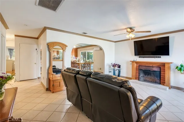 a living room with fireplace furniture and a flat screen tv