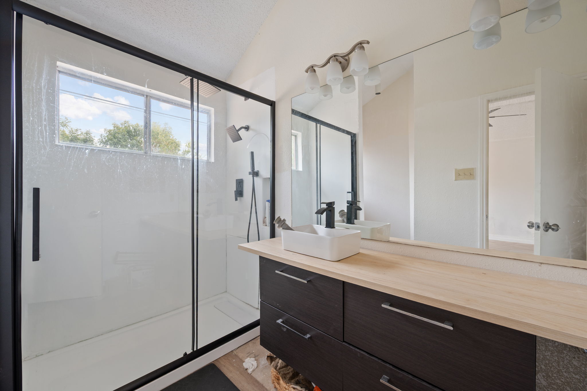 12501 Fallen Tower Lane Austin, TX 78753 - Photo 21 of 31 a bathroom with a sink a mirror and a shower