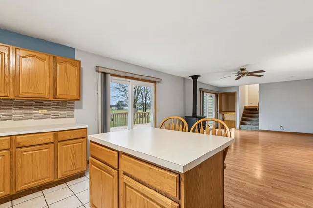 a front view of a house with barbeque oven and seating space