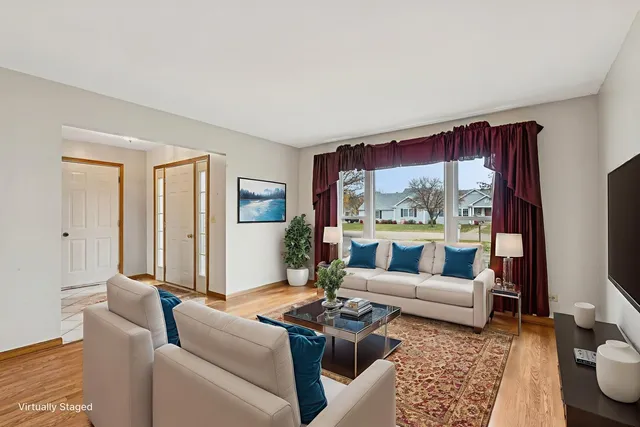a living room with furniture large window and a table