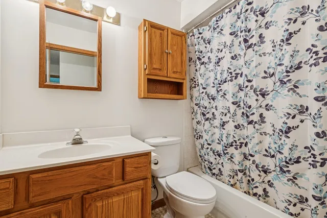 a bathroom with a sink toilet and mirror