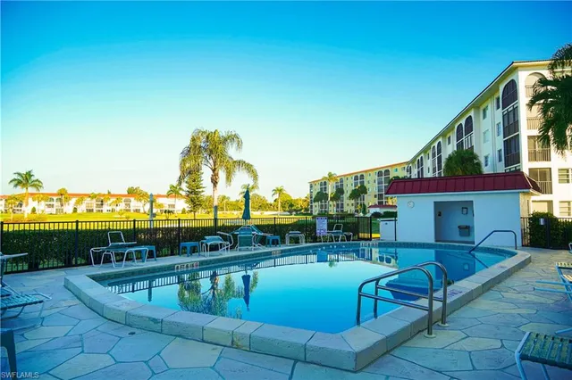 a front view of a building and trees