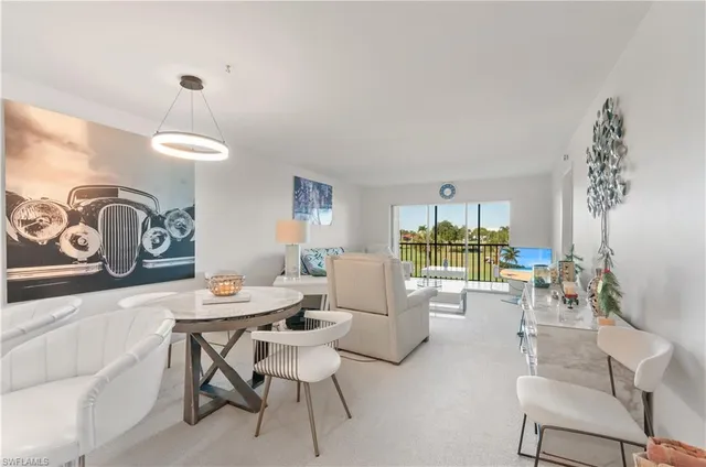 a dining room with furniture a chandelier and window