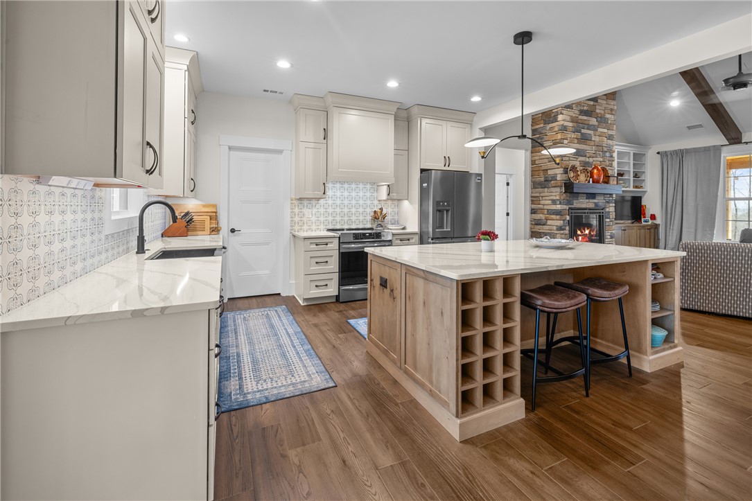 113 South Oak Pointe Drive Seneca, SC 29672 - Photo 12 of 50 This open concept kitchen features warm wood flooring and a beautiful kitchen island, perfect for gathering.