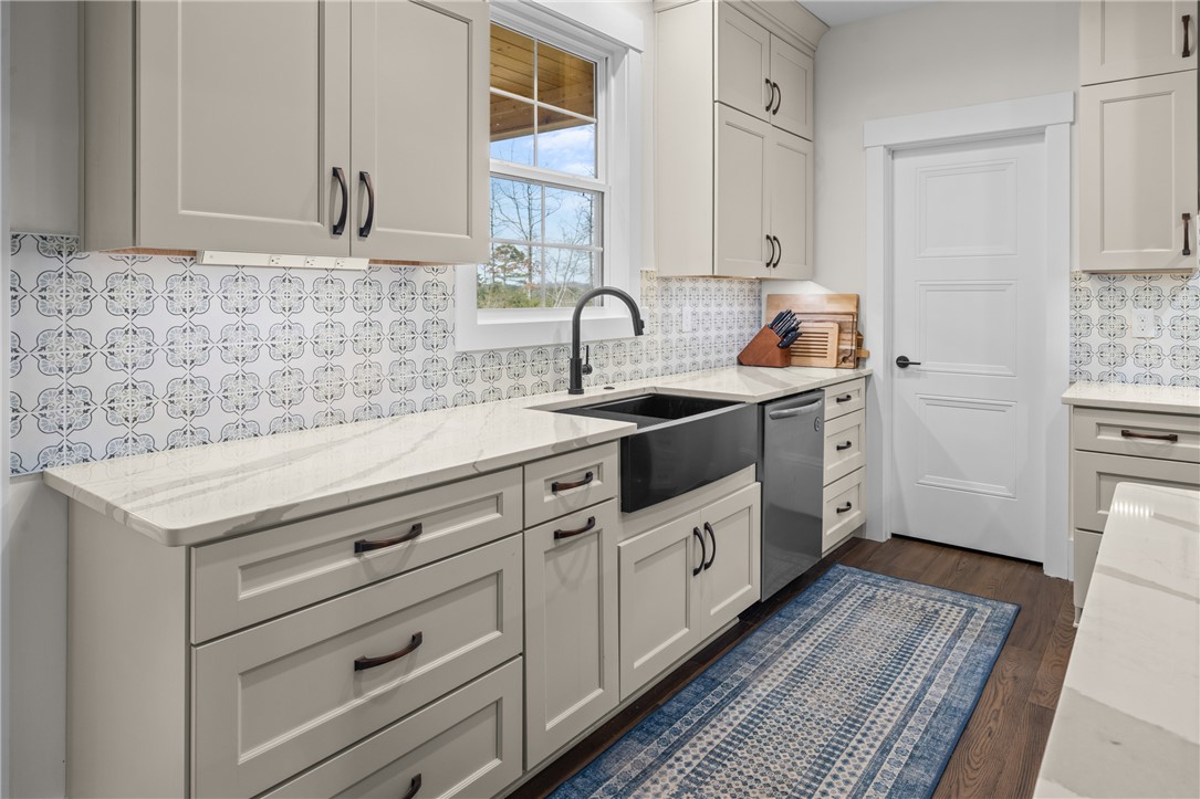 113 South Oak Pointe Drive Seneca, SC 29672 - Photo 13 of 50 This bright kitchen features sleek countertops, stylish cabinetry, and a modern sink.
