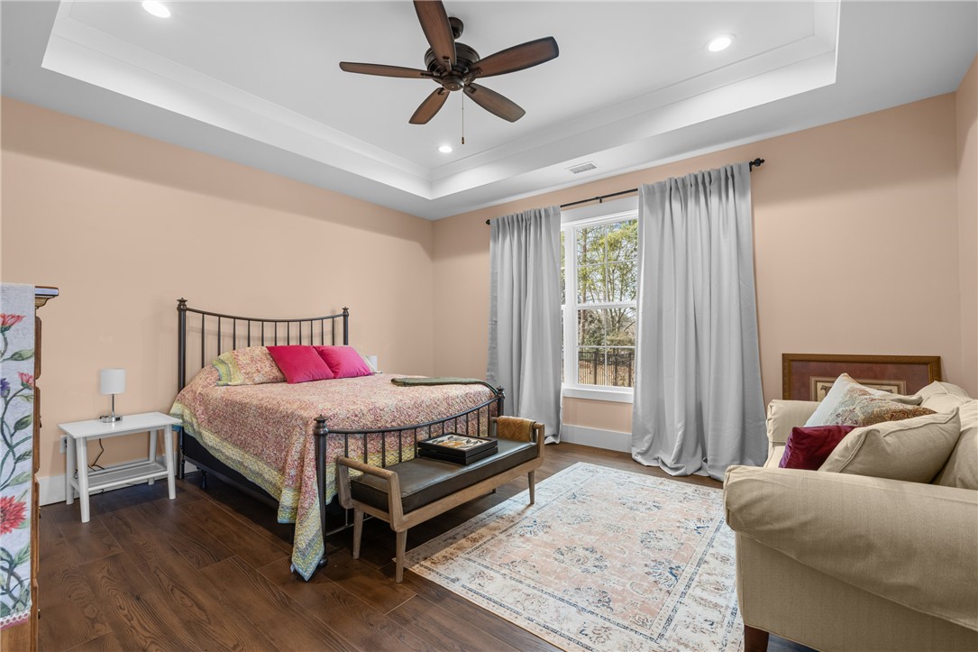 113 South Oak Pointe Drive Seneca, SC 29672 - Photo 20 of 50 This spacious bedroom features ample natural light and a stylish ceiling fan for comfort.