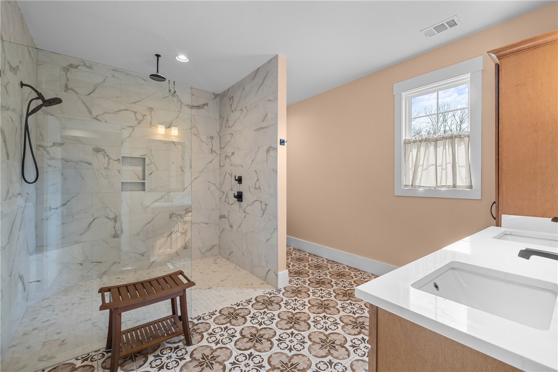 113 South Oak Pointe Drive Seneca, SC 29672 - Photo 22 of 50 This primary bathroom boasts a spacious walk-in shower and dual vanities, perfect for morning routines.