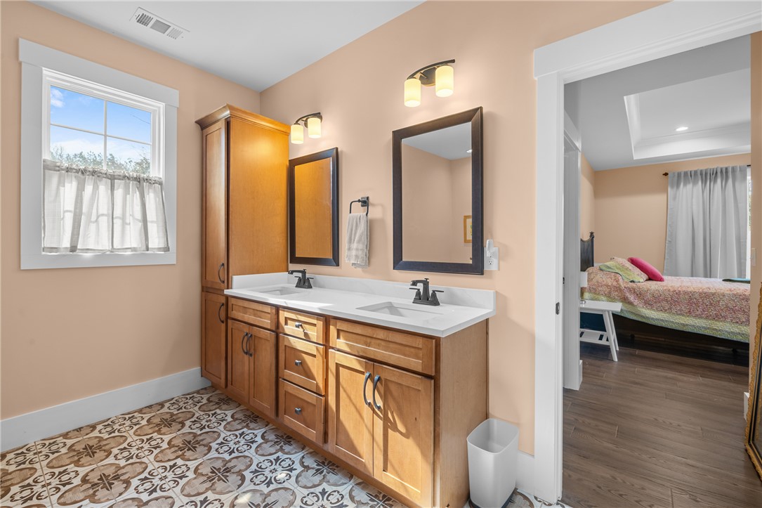 113 South Oak Pointe Drive Seneca, SC 29672 - Photo 23 of 50 This bathroom features a double vanity and patterned tile flooring.