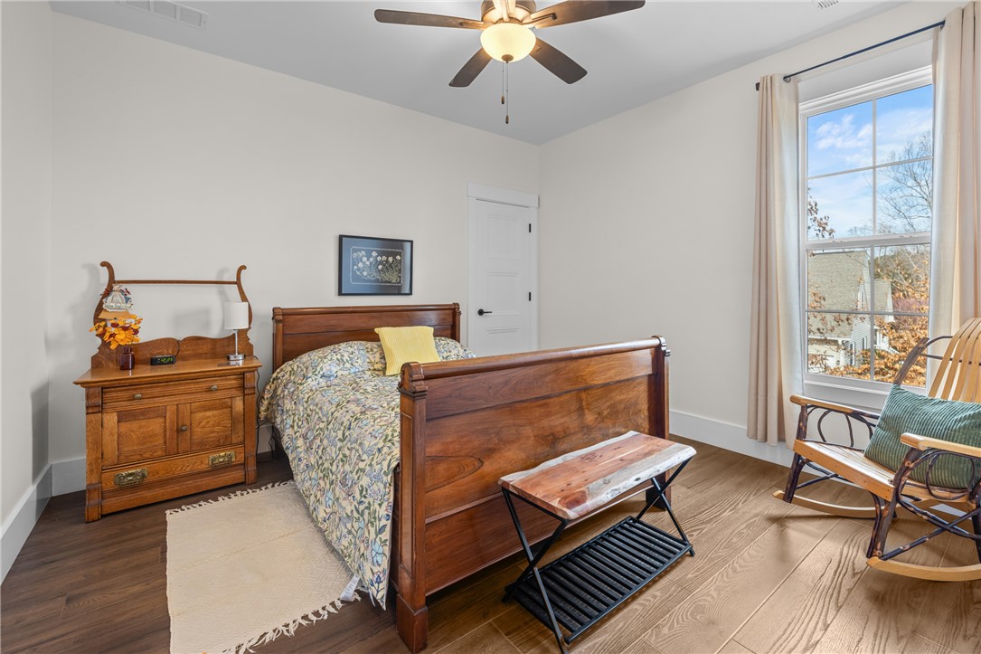113 South Oak Pointe Drive Seneca, SC 29672 - Photo 24 of 50 This cozy bedroom features elegant flooring and a large window, creating a serene and inviting atmosphere.