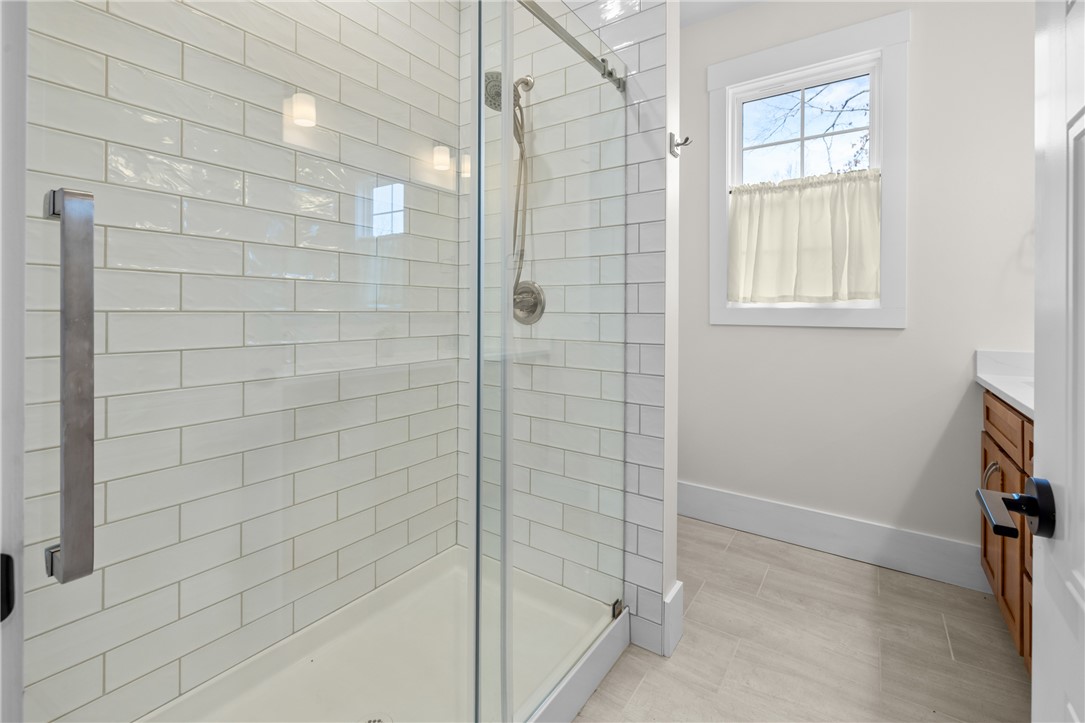 113 South Oak Pointe Drive Seneca, SC 29672 - Photo 25 of 50 This bright bathroom features a spacious shower with sleek subway tile and elegant fixtures.