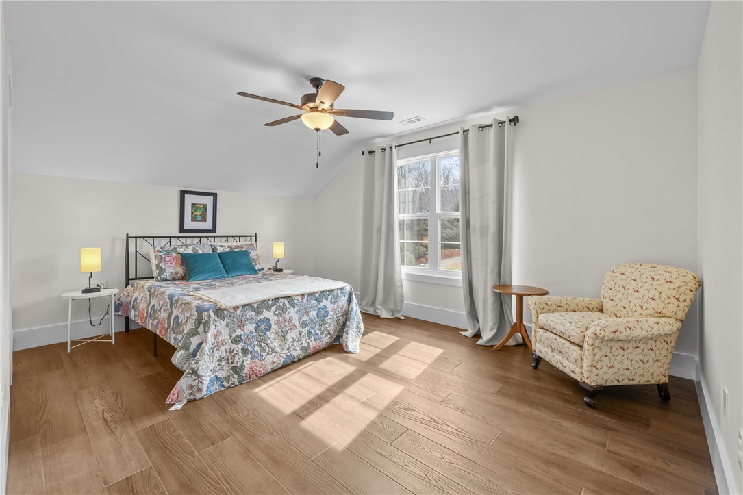 113 South Oak Pointe Drive Seneca, SC 29672 - Photo 29 of 50 This spacious bedroom features wood flooring, a ceiling fan, and ample natural light.
